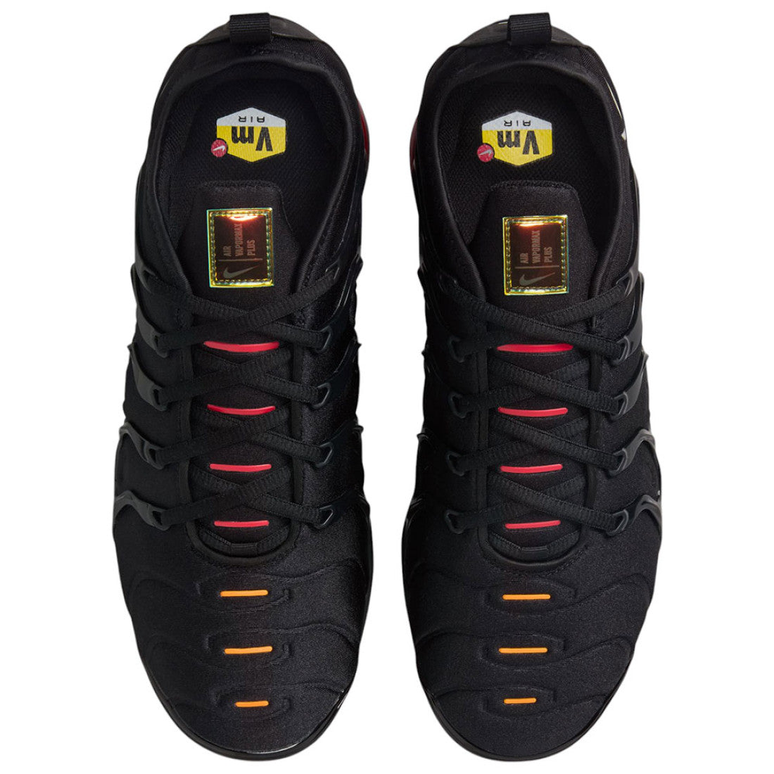 black and orange nike vapormax plus